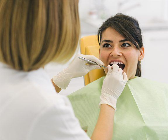 Woman attending dental checkup to prevent dental emergencies